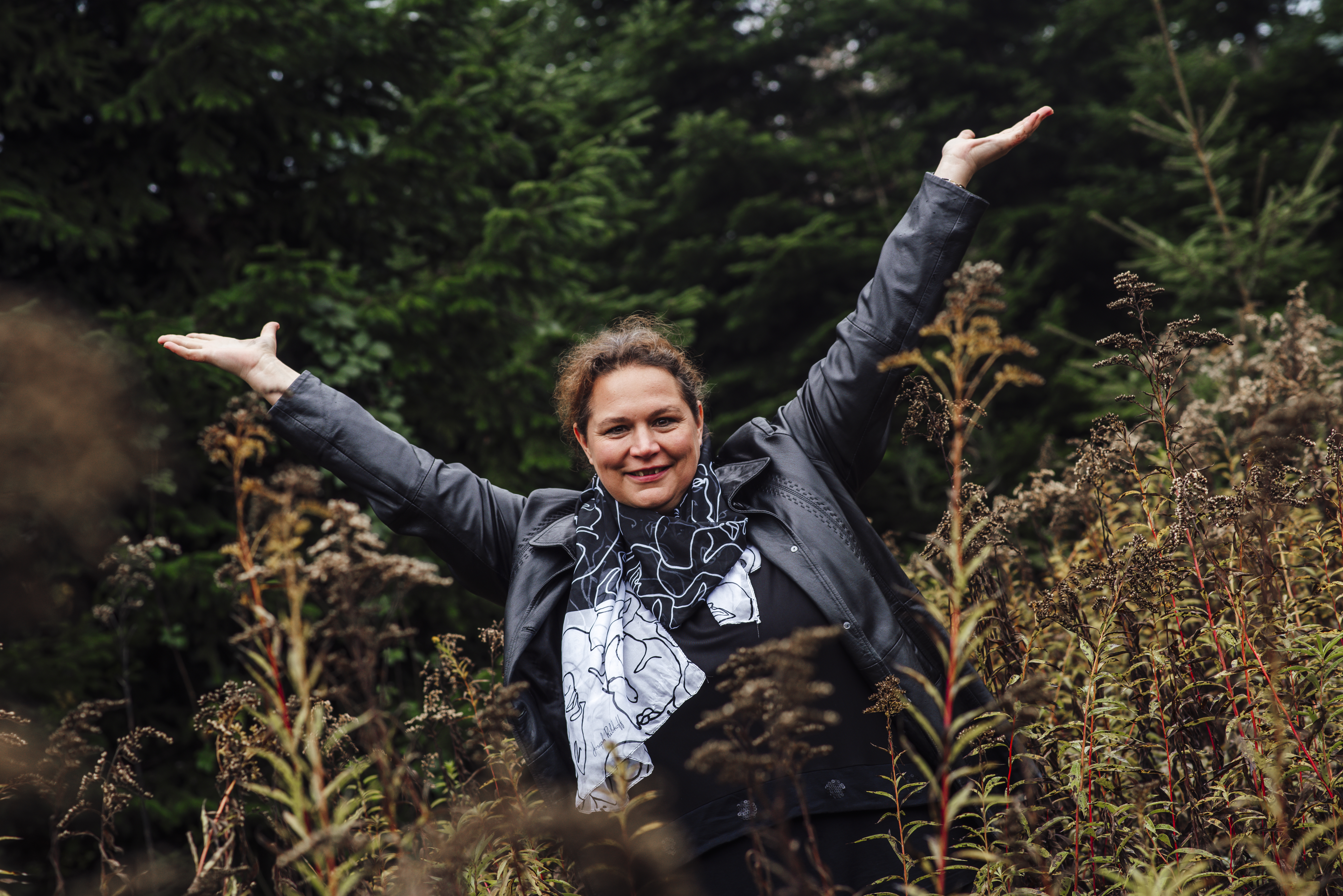 Michaela Thoma mit offenen Armen in der Natur — Raum für echte Begegnung